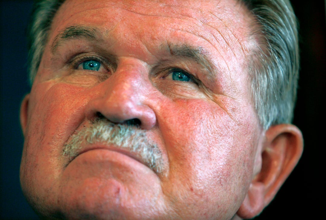 Former NFL player and head coach Mike Ditka listens to fellow former players speak at a news conference held by the Gridiron Greats Assistance Fund at the National Press Club in Washington June 26, 2007. Gridiron Greats is a group of retired NFL players who have come together to assist fellow players in dire need of financial or medical assistance due to inadequate disability or pensions. Ditka is on the board of the organization.
