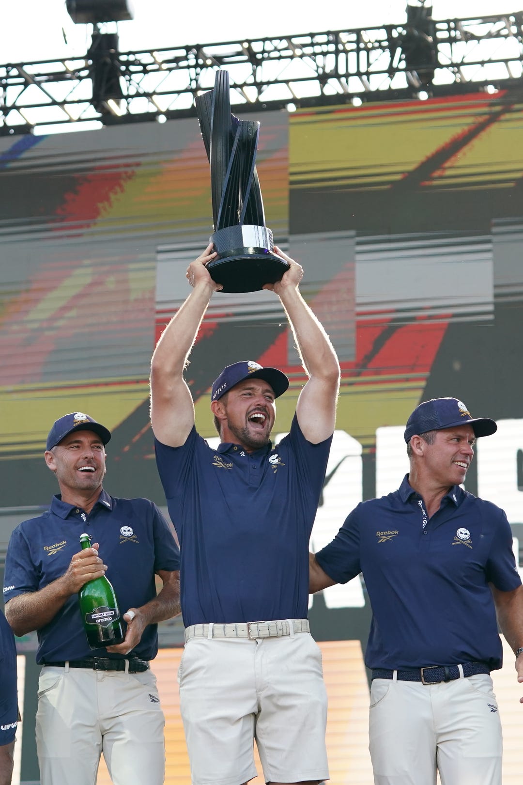 Charles Howell III, Bryson DeChambeau and Paul Casey of the Crushers GC celebrate the Dallas LIV team championship during the final round of the LIV Golf Dallas golf tournament at Maridoe Golf Club.