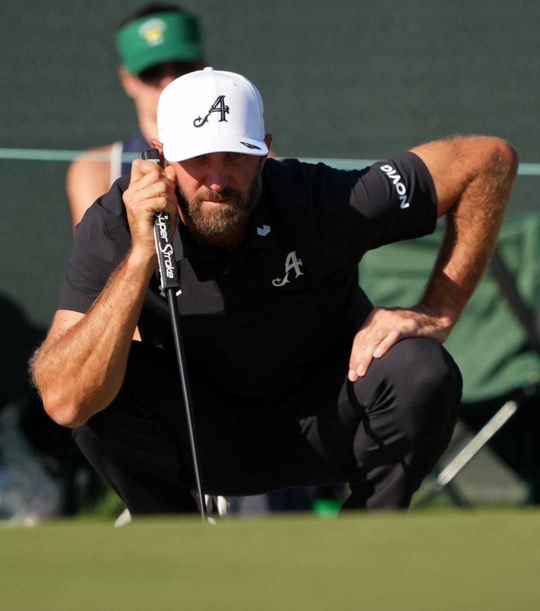 Dustin Johnson lines up a putt on the 17th green during the second round of the Masters Tournament at Augusta National Golf Club.